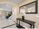 Elegant entryway boasting tile floors, a decorative mirror, and an ornamental table at 8636 Prairie Creek Dr, New Port Richey, FL 34655