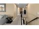 Upstairs hallway featuring hardwood floors, a stylish railing, and views of the downstairs area at 8636 Prairie Creek Dr, New Port Richey, FL 34655
