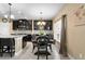 Open kitchen with dark cabinets, granite countertops, stainless steel appliances and an adjacent dining area at 8636 Prairie Creek Dr, New Port Richey, FL 34655