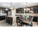 Spacious kitchen with dark wood cabinets, granite countertops, an island, and stainless steel appliances at 8636 Prairie Creek Dr, New Port Richey, FL 34655