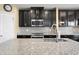 Kitchen showcasing a granite island, modern appliances, stylish backsplash, and a stainless sink at 8636 Prairie Creek Dr, New Port Richey, FL 34655