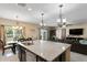 Spacious kitchen showcasing a granite-topped island, stainless steel appliances, and an adjacent dining area at 8636 Prairie Creek Dr, New Port Richey, FL 34655