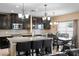 Spacious kitchen with an island, black cabinets, stainless steel appliances and an adjacent dining area at 8636 Prairie Creek Dr, New Port Richey, FL 34655