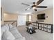 Comfortable living room with large couch, coffee table, and entertainment center with a TV at 8636 Prairie Creek Dr, New Port Richey, FL 34655