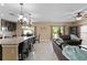 Open-concept living space featuring tile flooring, a modern kitchen, a dining area, and sliding glass doors at 8636 Prairie Creek Dr, New Port Richey, FL 34655