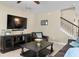 Cozy living room with a large television, comfortable seating, and a staircase leading to the second floor at 8636 Prairie Creek Dr, New Port Richey, FL 34655
