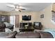 Relaxing living room with comfortable seating, a ceiling fan, and a staircase, perfect for Gathering gatherings at 8636 Prairie Creek Dr, New Port Richey, FL 34655
