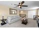 Comfortable living room with a large mirror above a light grey couch with a coffee table and end table at 8636 Prairie Creek Dr, New Port Richey, FL 34655