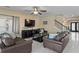 Comfortable living room area featuring tile flooring, staircase, natural light, and modern décor at 8636 Prairie Creek Dr, New Port Richey, FL 34655