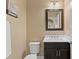 Well-lit powder room featuring a vanity with a white countertop and a modern mirror at 8636 Prairie Creek Dr, New Port Richey, FL 34655