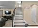 Elegant staircase featuring dark wood and white risers, connecting the living room to the upper level at 8636 Prairie Creek Dr, New Port Richey, FL 34655