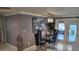 Dining area with glass table, blue chairs, light fixture and an elegant decorative painting on the wall at 9161 56 Th, Pinellas Park, FL 33782