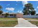 Charming single-story home with a well-maintained lawn, driveway and mature trees at 9161 56 Th, Pinellas Park, FL 33782