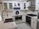 Modern kitchen with white cabinets, granite countertops and stainless steel appliances at 9161 56 Th, Pinellas Park, FL 33782