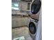 Modern laundry room with stacked washer and dryer and under window sink at 9161 56 Th, Pinellas Park, FL 33782