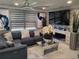Cozy living room with a large sectional sofa, stone accent wall and modern fireplace at 9161 56 Th, Pinellas Park, FL 33782