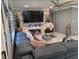 Comfortable living room space offering a sectional sofa, modern fireplace and large windows at 9161 56 Th, Pinellas Park, FL 33782