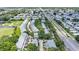 Aerial view of a condo community situated next to a tranquil pond and a bustling highway at 9205 Jakes Path, Largo, FL 33771