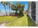 Expansive backyard with lush green grass and meticulously landscaped gardens, perfect for outdoor enjoyment at 9205 Jakes Path, Largo, FL 33771