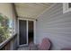 Cozy balcony features a chair and sliding glass door, providing access to a bedroom at 9205 Jakes Path, Largo, FL 33771