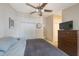 Comfortable bedroom with neutral walls, ceiling fan, plush carpet, and ample closet space at 9205 Jakes Path, Largo, FL 33771