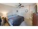 Bedroom with ceiling fan, neutral walls, plush carpet, and ample closet space at 9205 Jakes Path, Largo, FL 33771