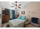 Bedroom featuring a ceiling fan, a chest of drawers, and a comfortable chair for relaxation at 9205 Jakes Path, Largo, FL 33771