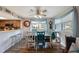Dining area with wood-look floors, colorful furniture and decor, and bright natural light at 9205 Jakes Path, Largo, FL 33771