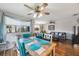 Open dining area features wood-look floors, colorful furniture, ceiling fan, and lots of natural light at 9205 Jakes Path, Largo, FL 33771