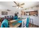 Dining area with a view into the living room and kitchen, wood-look floors, and colorful decor at 9205 Jakes Path, Largo, FL 33771