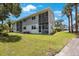 Charming two-story home with balconies, well-manicured lawn, and inviting curb appeal at 9205 Jakes Path, Largo, FL 33771