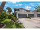 Charming two-story townhome features a two-car garage, well-maintained landscaping, and inviting curb appeal at 9205 Jakes Path, Largo, FL 33771
