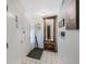 Inviting foyer features tiled flooring and decorative mirror at 9205 Jakes Path, Largo, FL 33771