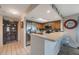 Well-lit kitchen features stainless steel appliances and breakfast bar at 9205 Jakes Path, Largo, FL 33771