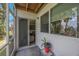 View of the screened in patio with sliding glass doors and potted plant creating an inviting outdoor living space at 9205 Jakes Path, Largo, FL 33771