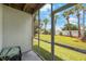Inviting screened-in porch with views of the landscaped backyard and lush green lawn at 9205 Jakes Path, Largo, FL 33771