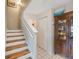 Stairway leading to the upper level, featuring hardwood steps and tile floors at 9205 Jakes Path, Largo, FL 33771