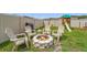 Fenced backyard with stone firepit and play structure, ideal for outdoor enjoyment and entertainment at 9815 Carabiner Way, Land O Lakes, FL 34637
