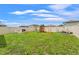 Spacious fenced backyard with play area and garden, offering ample space for recreation at 9815 Carabiner Way, Land O Lakes, FL 34637