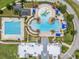 Aerial view of community pool with various aquatic activities and lounge areas at 9815 Carabiner Way, Land O Lakes, FL 34637