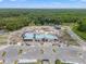 Aerial view of community center construction with abundant parking and surrounding greenspace at 9815 Carabiner Way, Land O Lakes, FL 34637