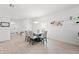 Bright dining area boasts a modern chandelier and a glass-top table, creating an elegant space for meals at 9815 Carabiner Way, Land O Lakes, FL 34637