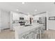 Modern kitchen featuring stainless steel appliances, white cabinets, a large center island and barstool seating at 9815 Carabiner Way, Land O Lakes, FL 34637