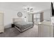 Serene primary bedroom with plush carpeting, a ceiling fan, and neutral decor for a relaxing retreat at 9815 Carabiner Way, Land O Lakes, FL 34637