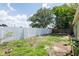 Spacious backyard featuring a white concrete wall providing privacy at 1040 Bridlewood Way, Brandon, FL 33511