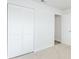 A bright bedroom with a closet and a view into the hallway at 1040 Bridlewood Way, Brandon, FL 33511