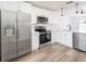 Modern kitchen features stainless appliances, white cabinets, a dishwasher, and laminate flooring at 1040 Bridlewood Way, Brandon, FL 33511