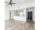 Open-concept living room features laminate floors, modern ceiling fan, and flows into the kitchen at 1040 Bridlewood Way, Brandon, FL 33511
