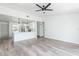 Spacious living room with an open floor plan, modern ceiling fan, and bright, neutral decor at 1040 Bridlewood Way, Brandon, FL 33511