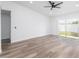 Bright, airy living room featuring laminate flooring, neutral paint, and a sliding glass door to the back at 1040 Bridlewood Way, Brandon, FL 33511